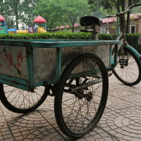 Faded blue bicycle carts in Qing Yun Dian, China. Sacrificial Love.