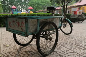 Faded blue bicycle carts in Qing Yun Dian, China. Sacrificial Love.